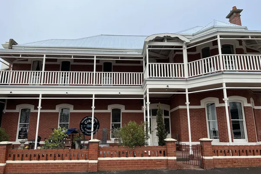 The Inn's two-storey red-brick front on Hesse Street, with white verandahs on both floors